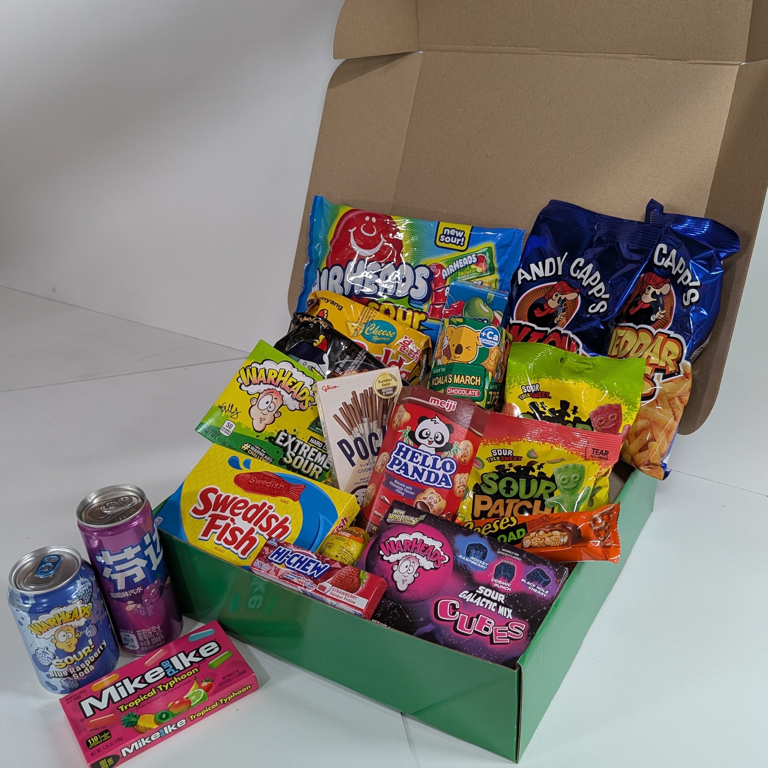 Assorted candy and snack box with various brands on a white background