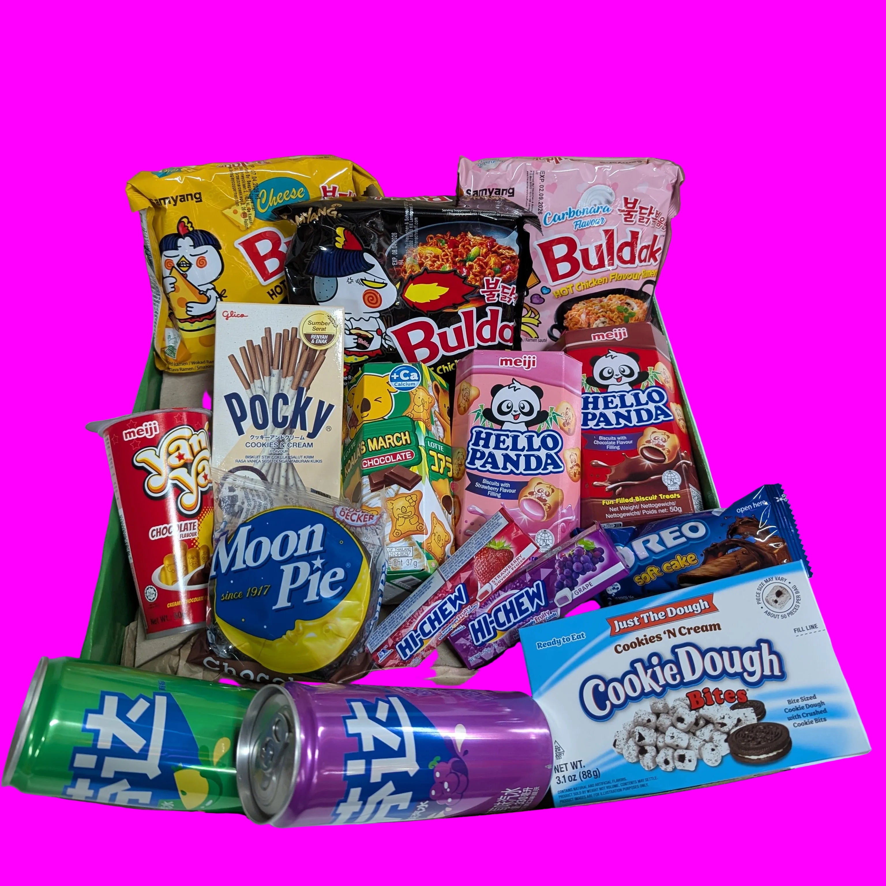 Assorted snack box with various branded items including cookies, candy, and drinks on a white surface.