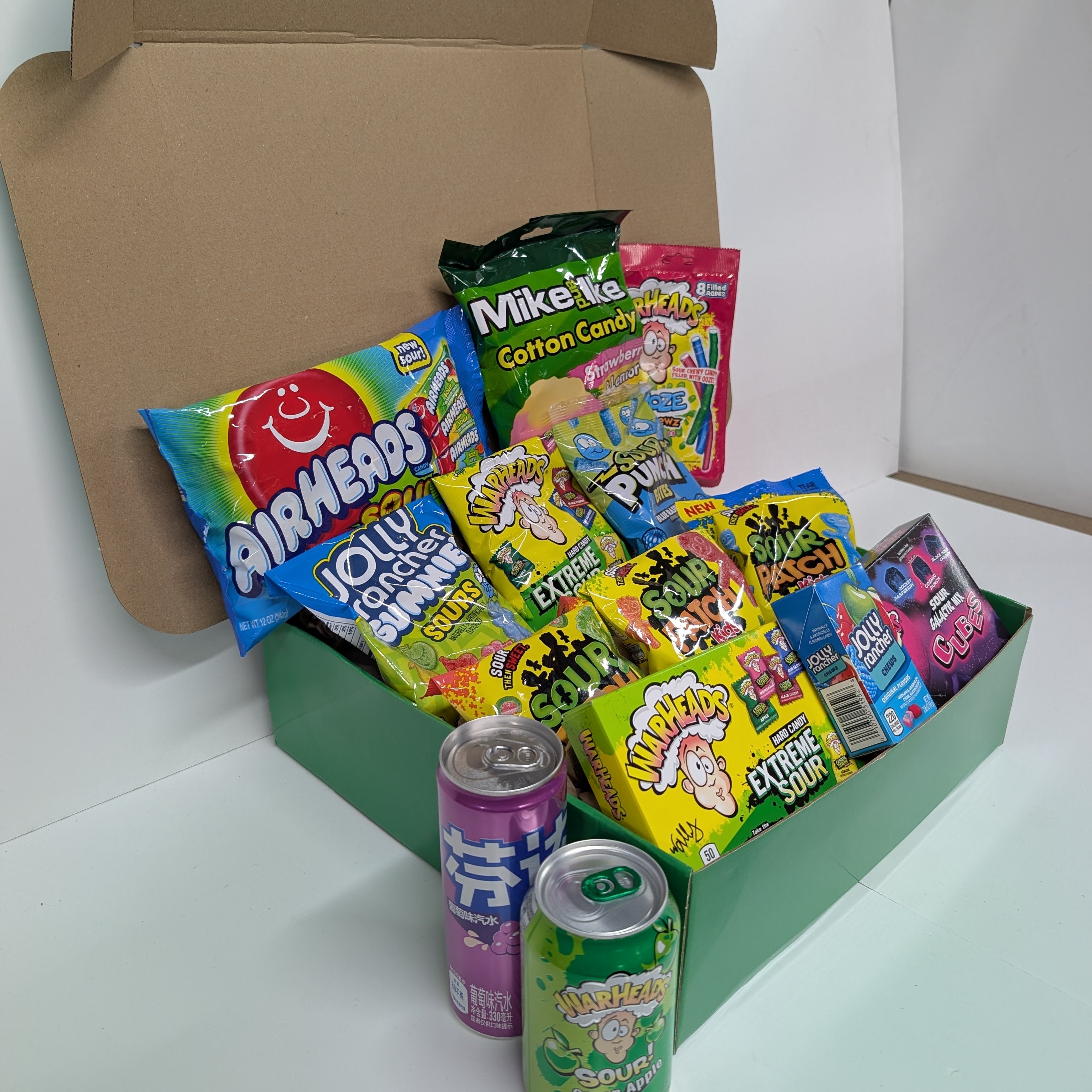 Assorted candy and drinks in a box on a white background