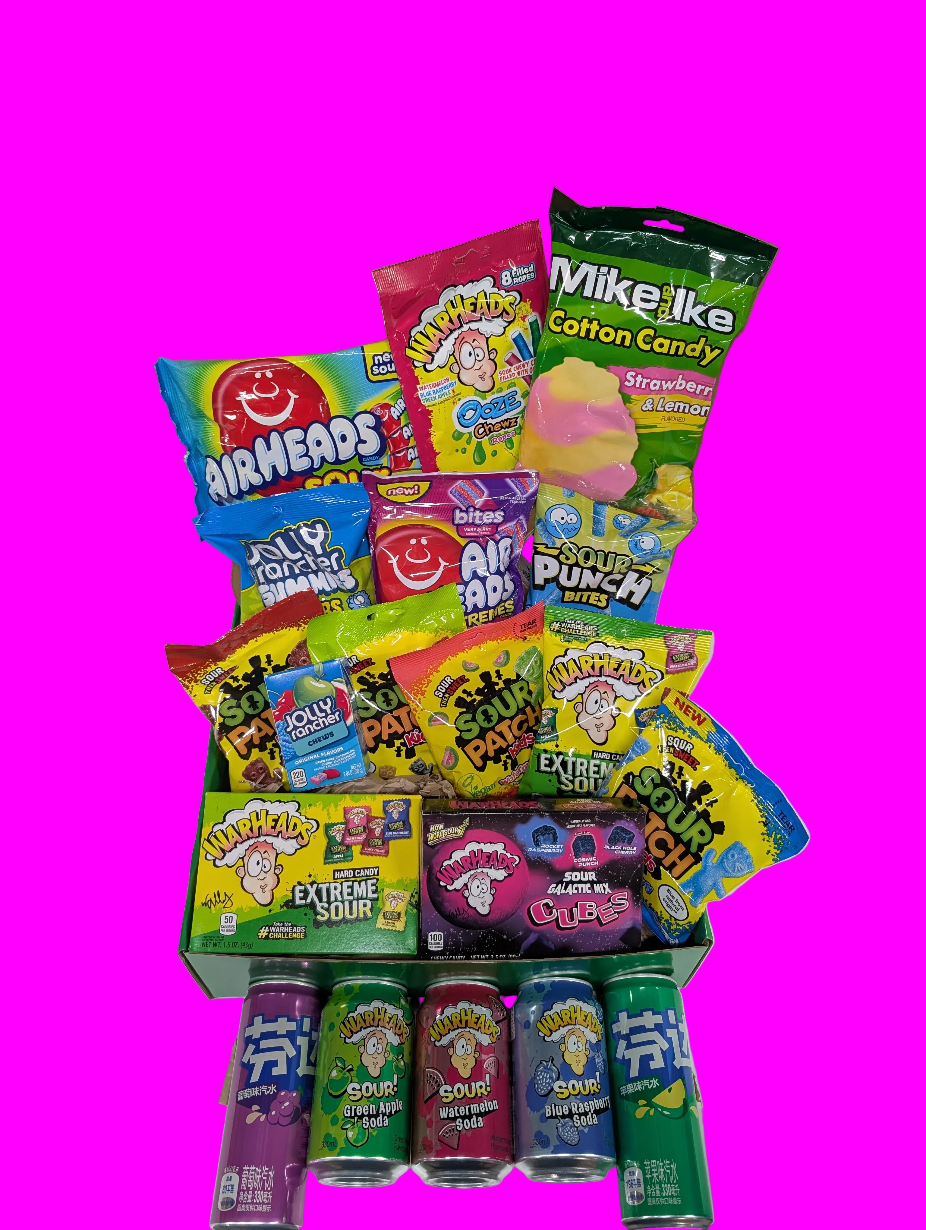 Assorted candy and soda pop in a box on a white background