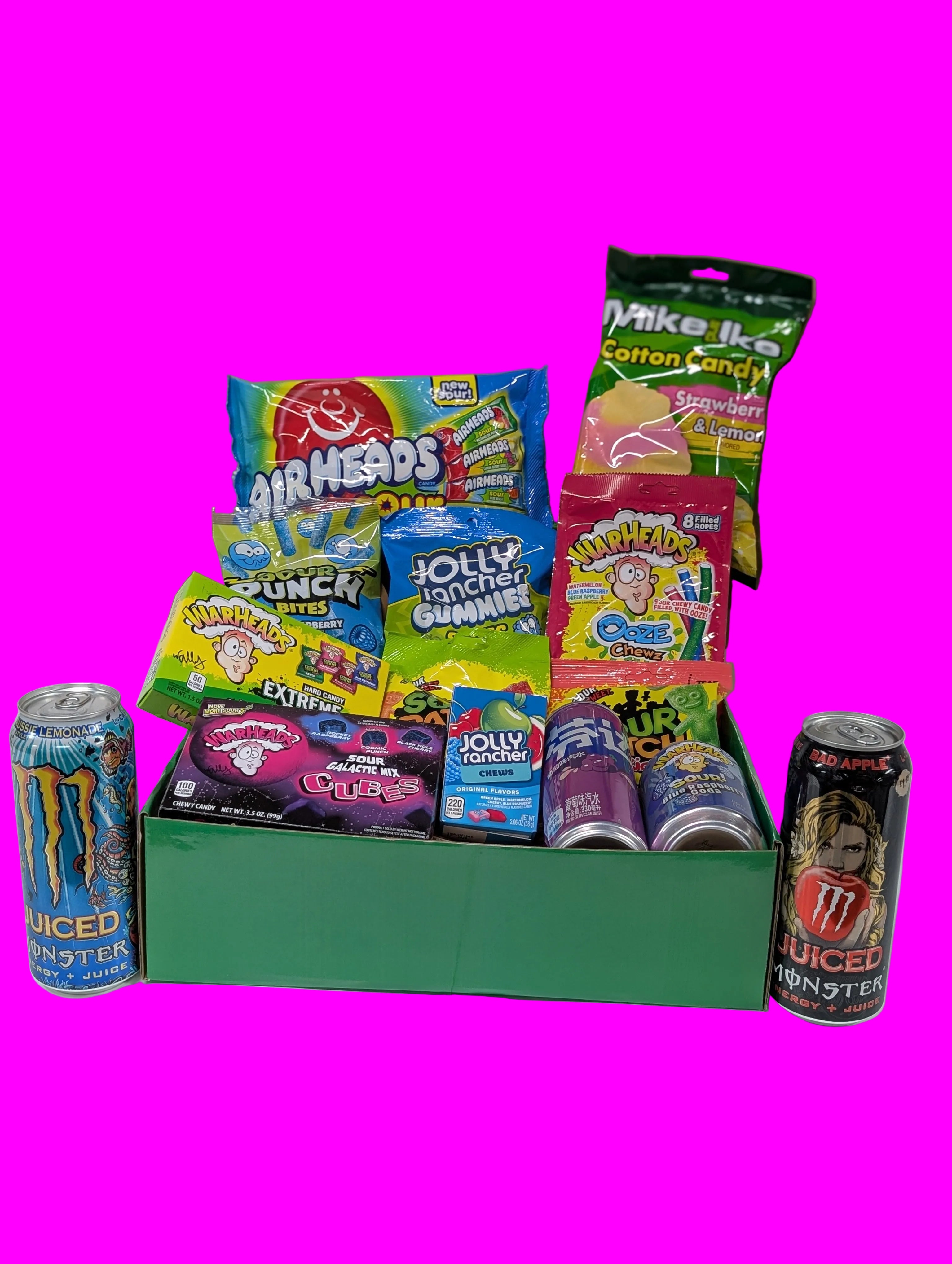 Box of candy and energy drink cans on a white surface
